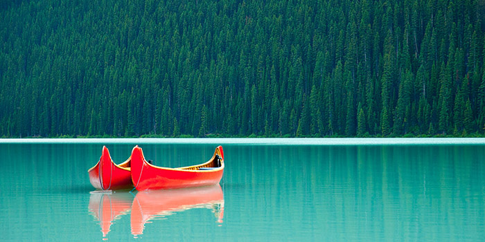 Canoes floating peacufully on Lake Louise near Banff.