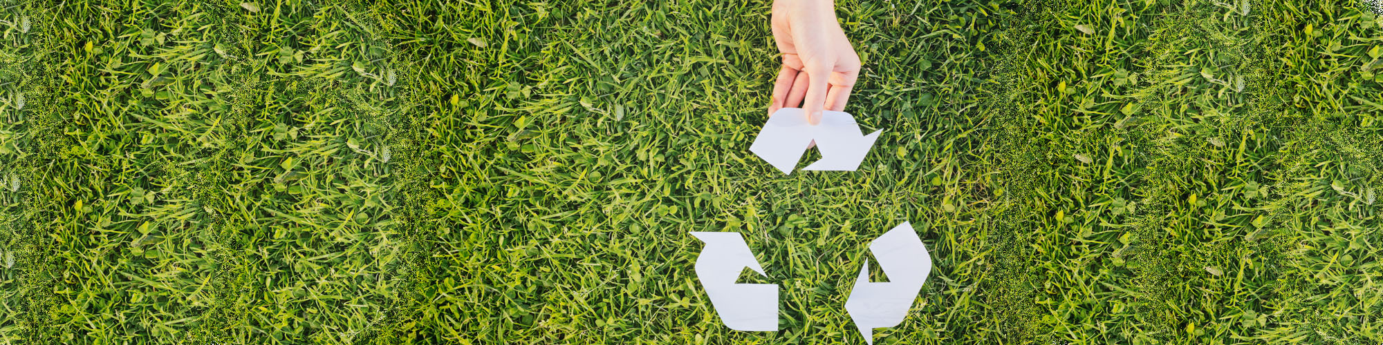 Recycling icon on grass