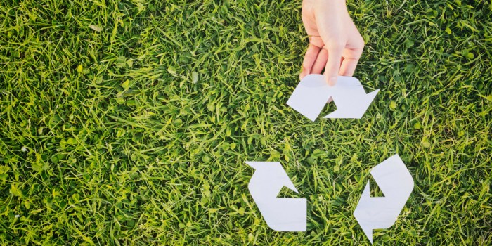 Recycling icon on grass