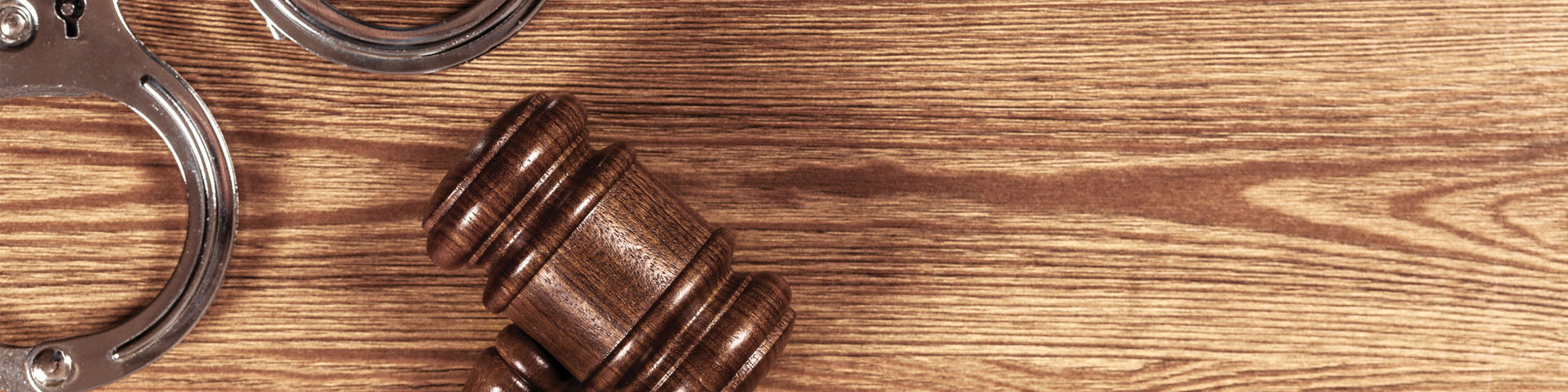 handcuffs and gavel on desk for recycling fraud
