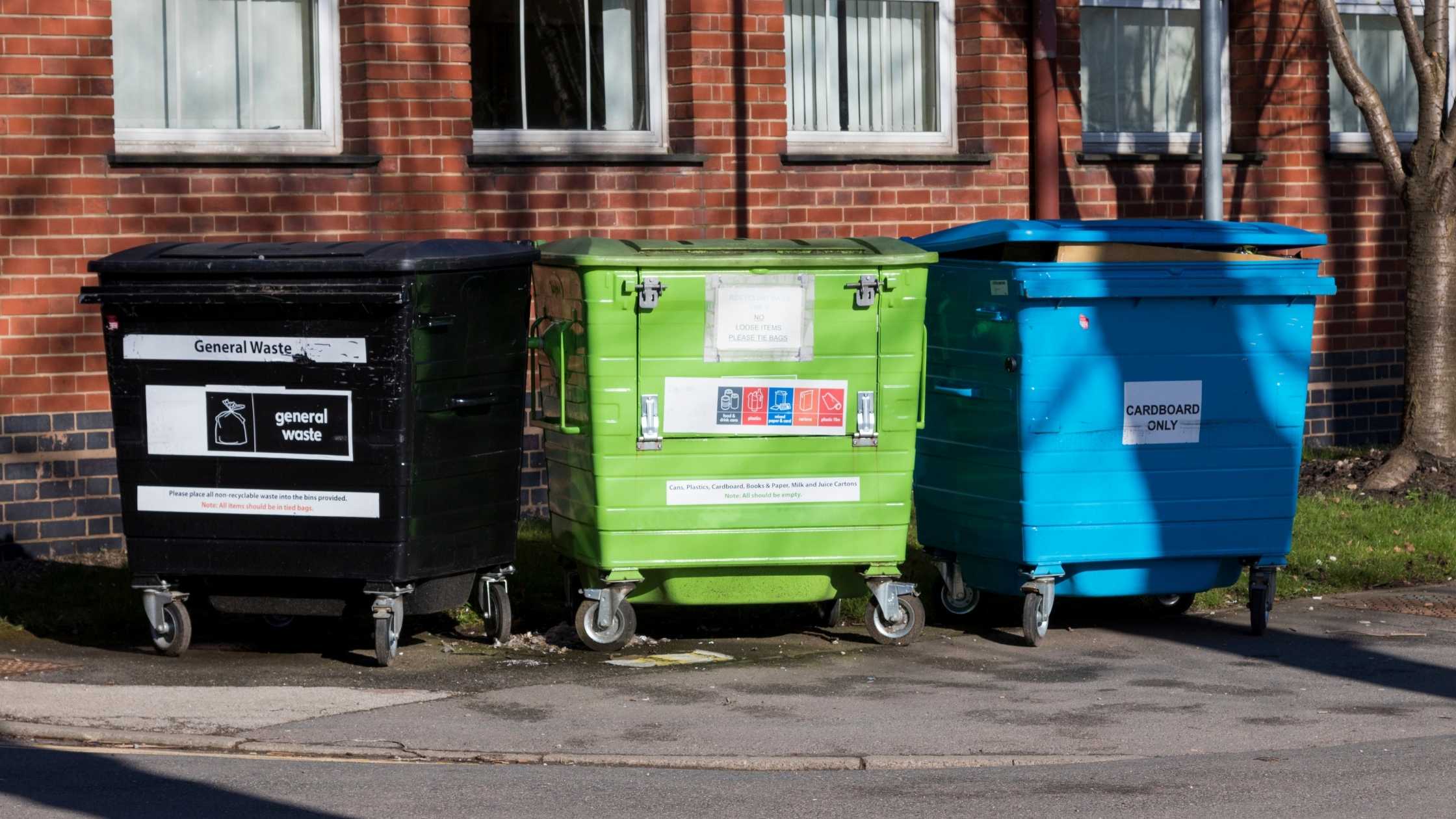 image showing three waste containers - recycling, garbage, and organic