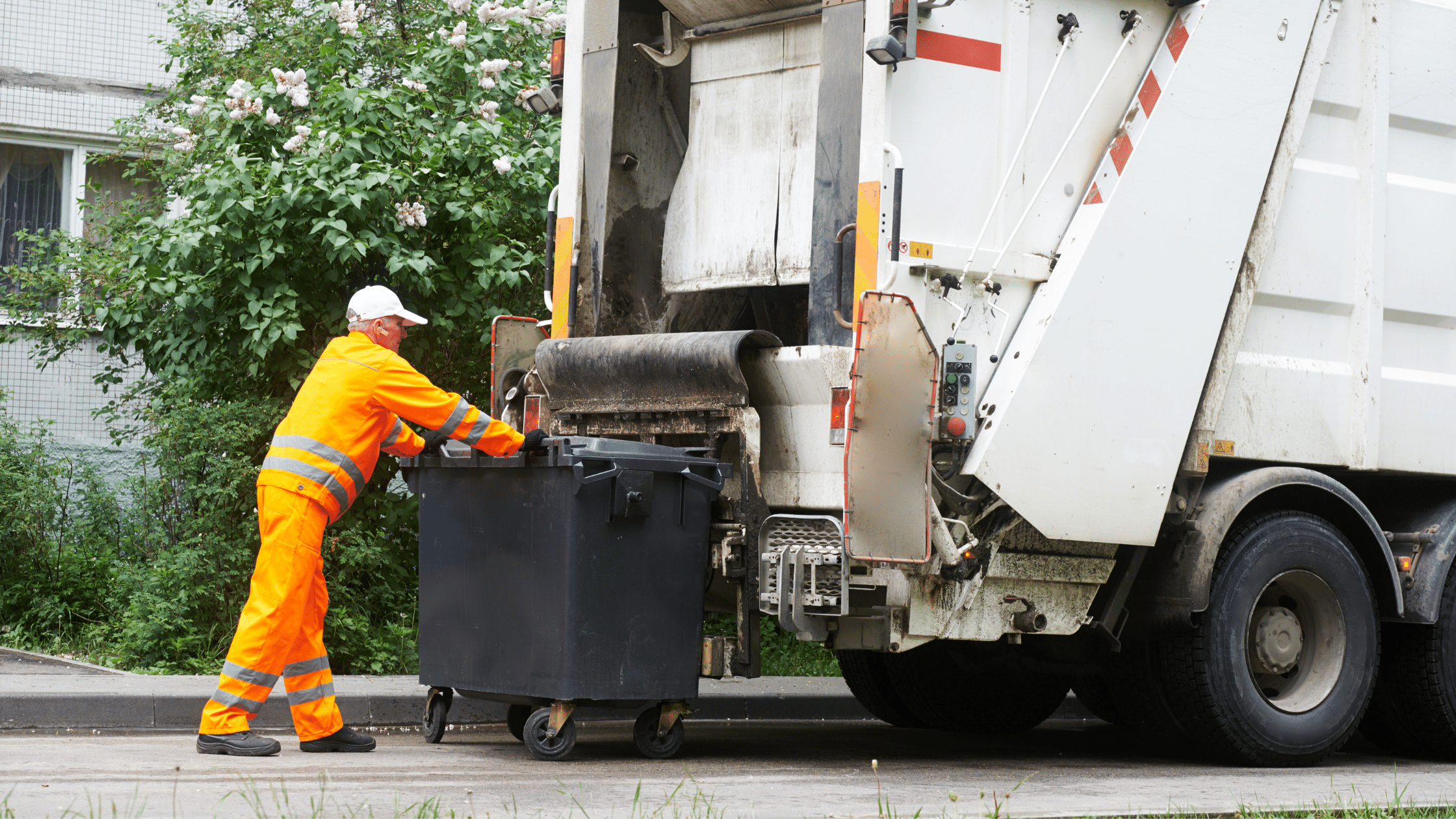 image showing dumpster about to be emptied into packer garbage truck