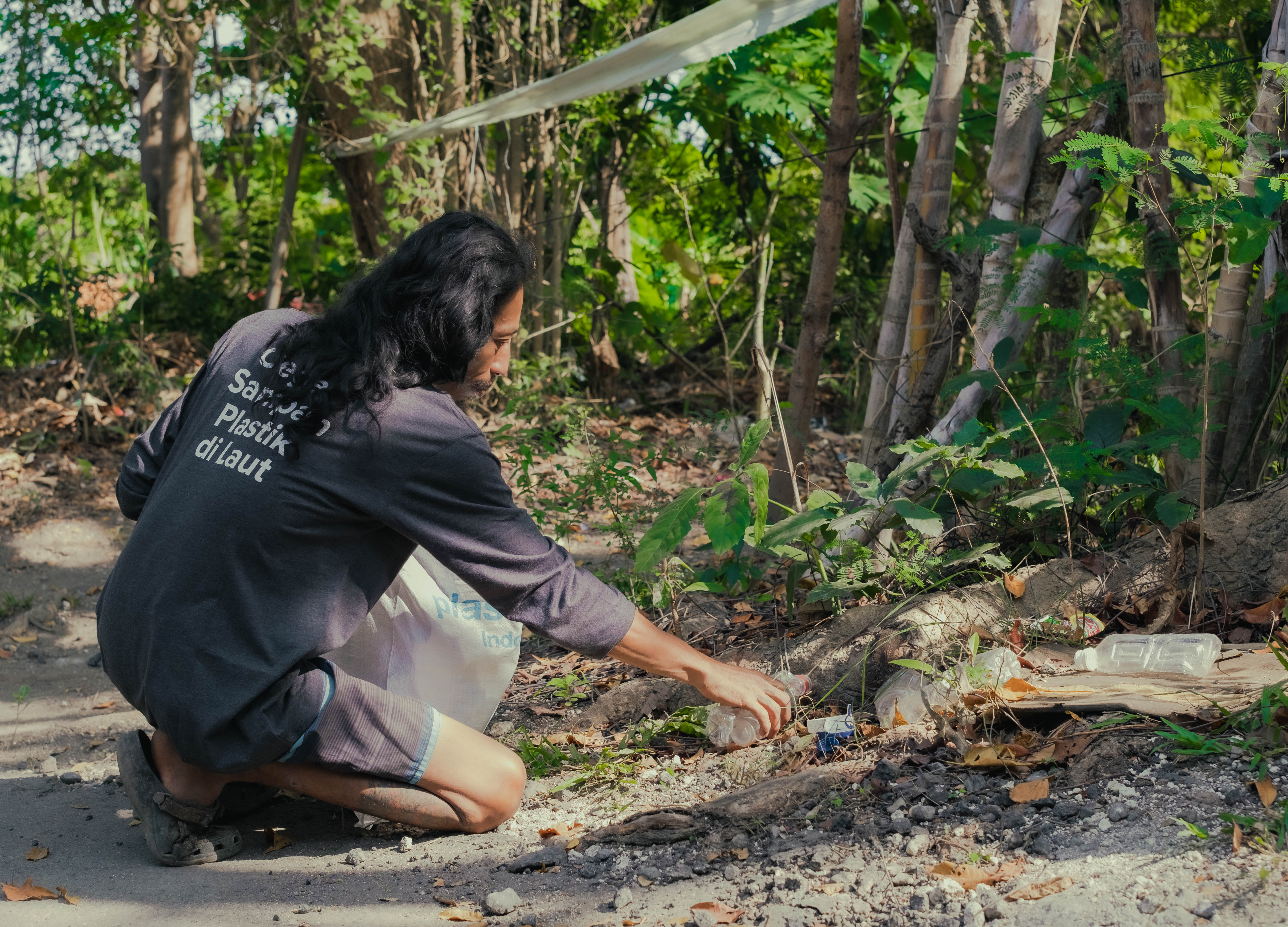 Haris collecting plastic. Photo courtesy of Plastic Bank