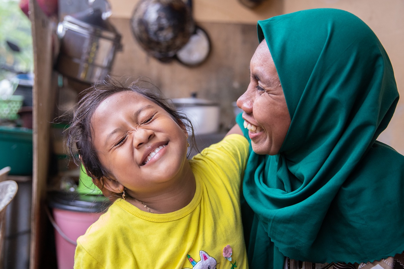 The happiness of Atmawaki’s daughter (Nurmalika) as she sees her mother come home after collecting Plastic at the beach. Photo courtesy of Plastic Bank