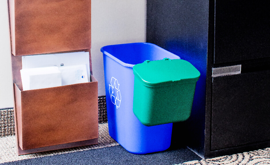 Busch Systems Recycling container in blue with mobius loop graphic and green hanging waste basket