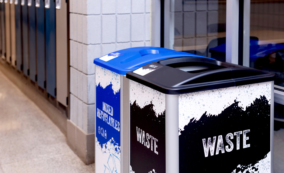 Mosaic Series mixed recyclables and waste containers with custom signs and labels in college hallway