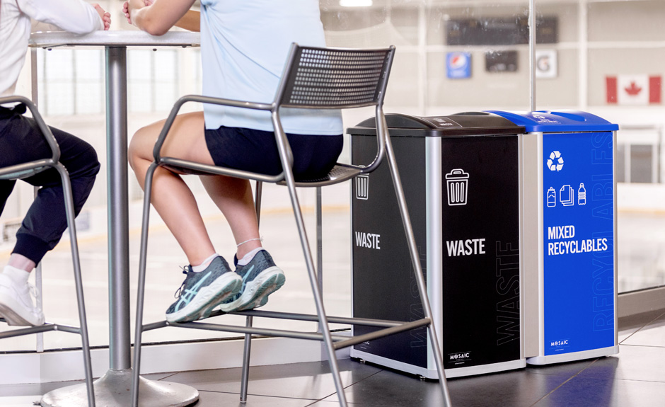 Mosaic Series mixed recyclables and waste containers with custom signs in community sports center