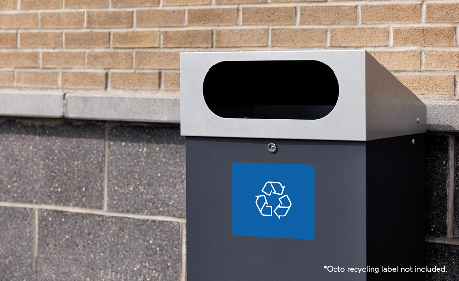 Busch systems reflection outdoor waste and recycling container shown with recycling label in a shopping plaza
