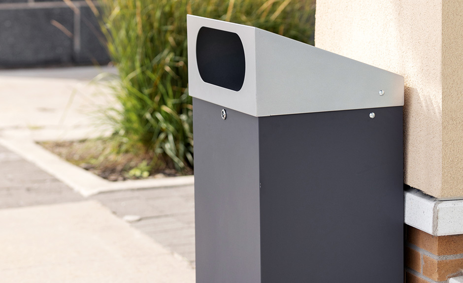 Busch systems reflection outdoor waste and recycling container shown in a shopping plaza