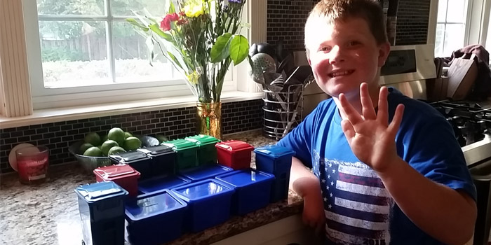 boy with small recycling and waste containers