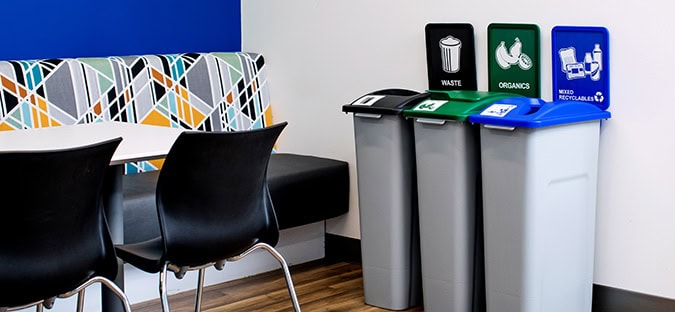 Busch Systems Waste Watcher Series waste recycling and organics containers in an office lunch room