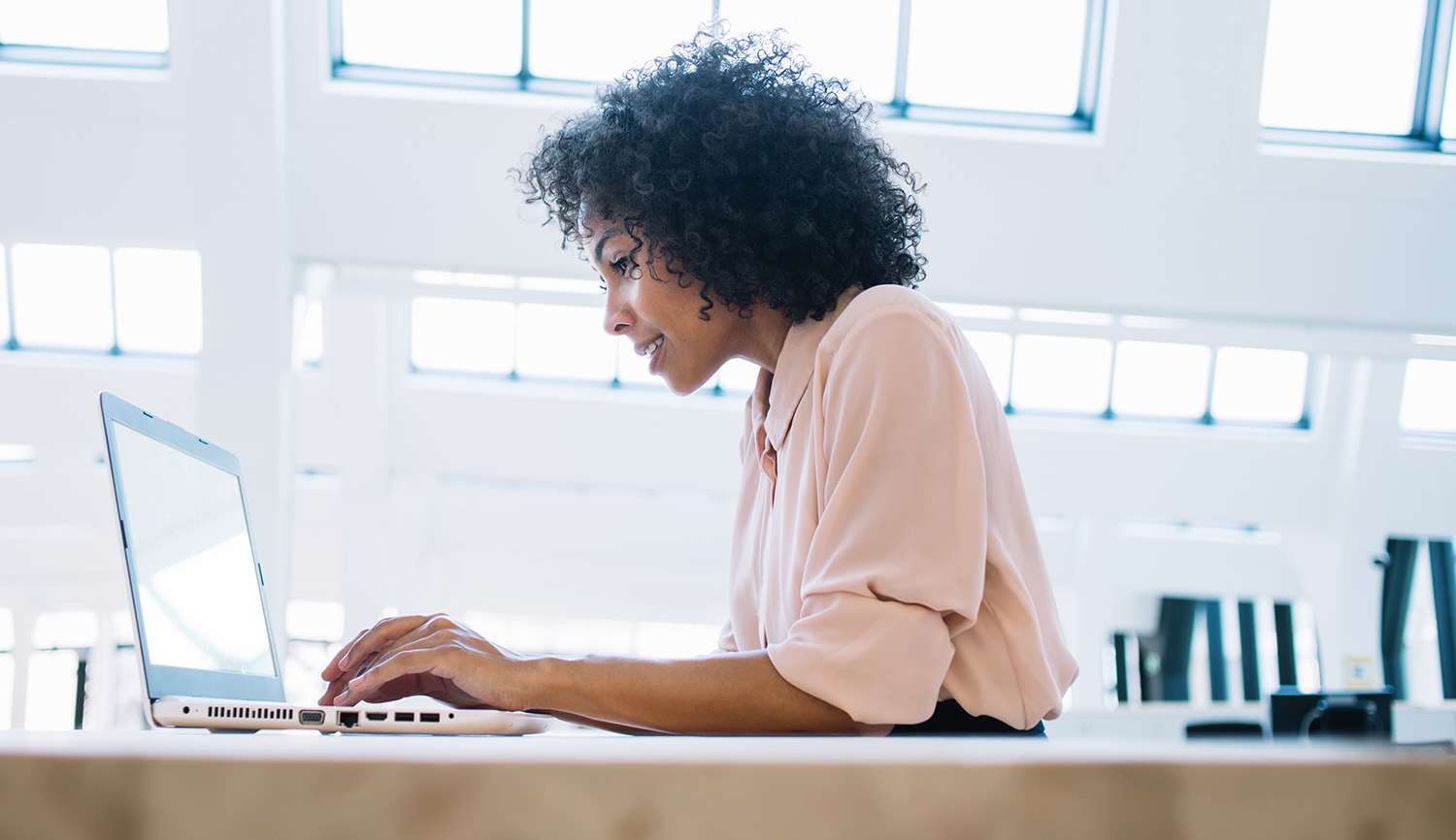 a woman staring at her laptop
