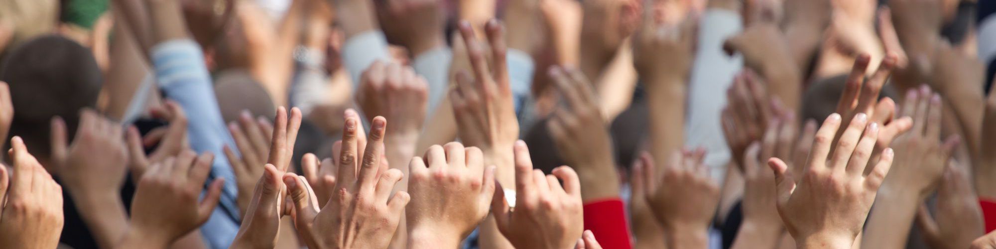 Crowd raising hands