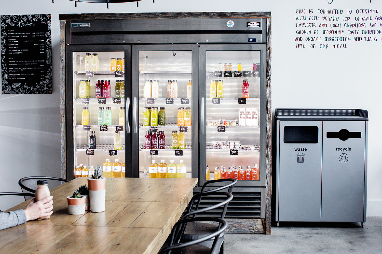 Beverages fridge next to waste and recycle bins