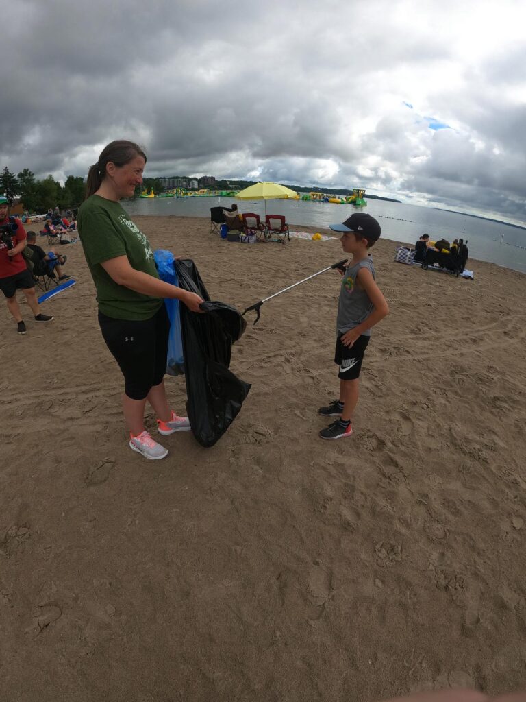 barrie beach cleanup with woman and young boy picking up trash