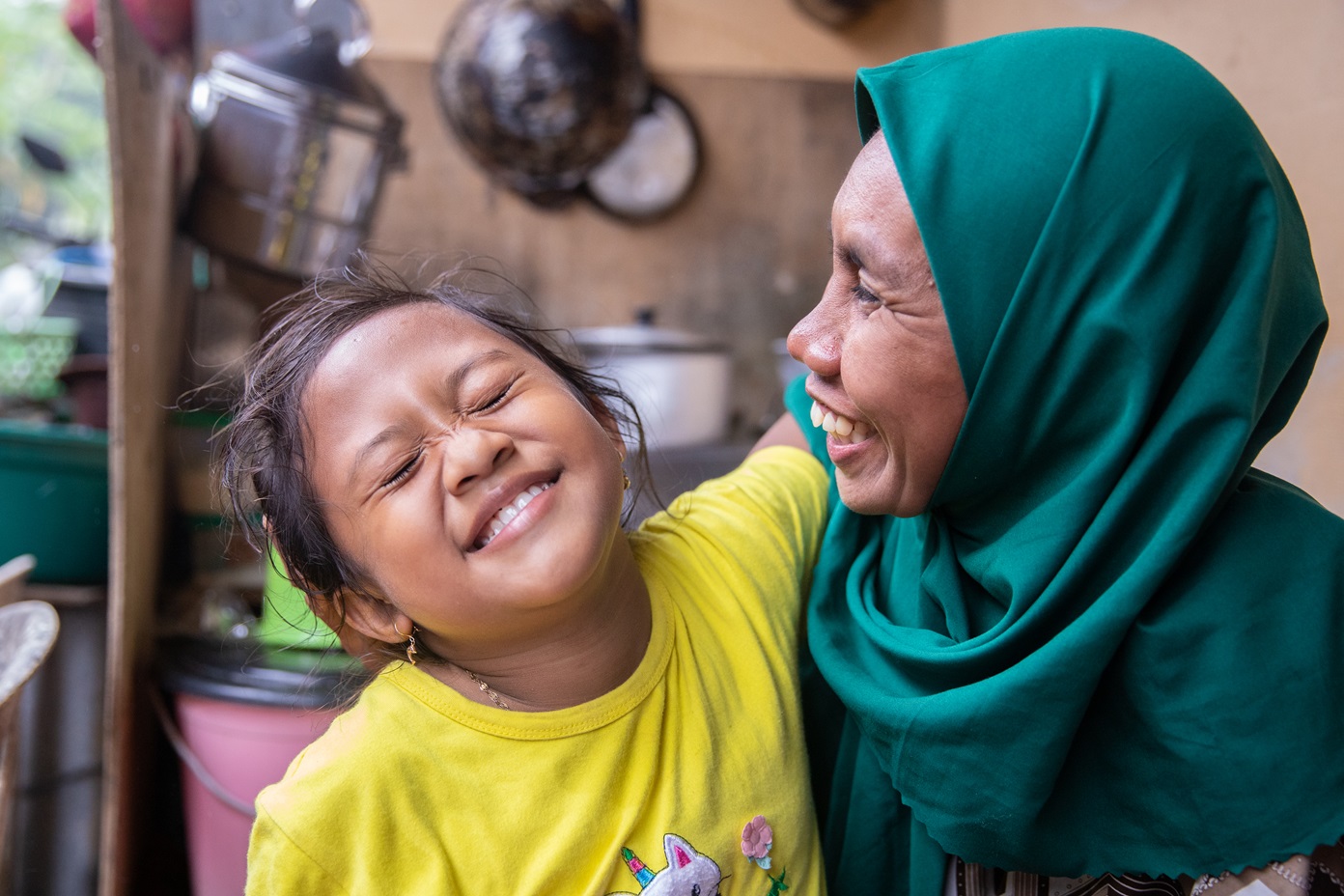 The happiness of Atmawaki’s daughter (Nurmalika) as she sees her mother come home after collecting Plastic at the beach. Photo courtesy of Plastic Bank
