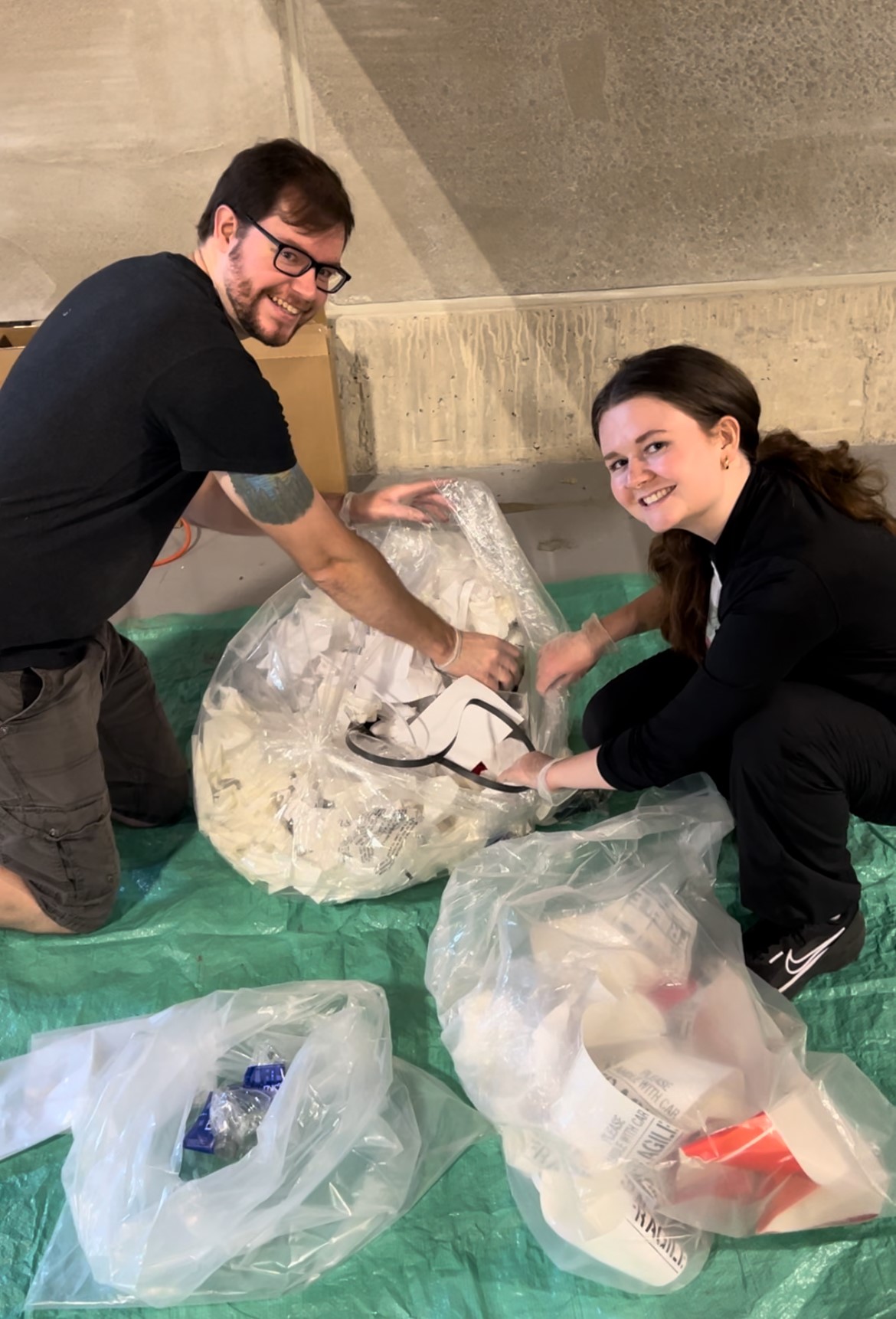 Two people sorting waste during a waste audit